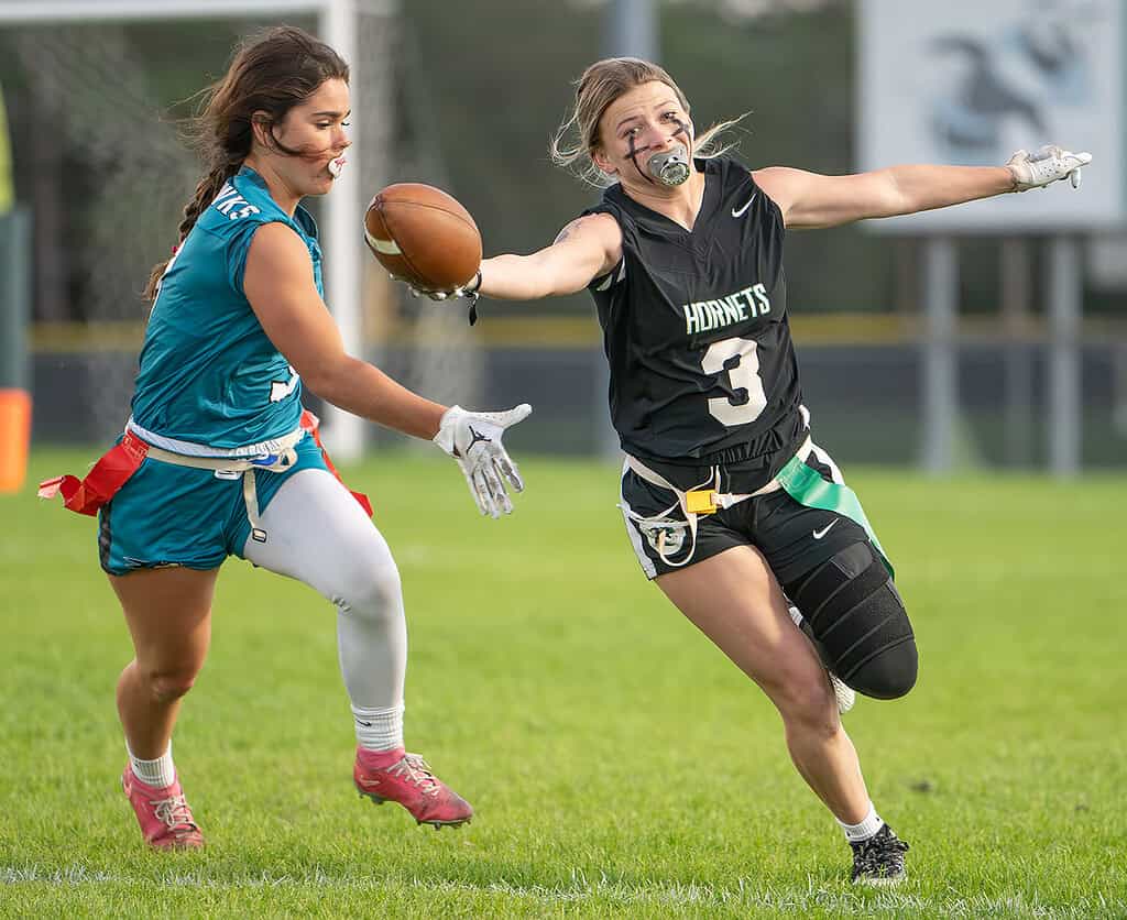 Weeki Wachee High ,3, Delanie Evans stretches for a first down before the flag pull by Sunlake High's ,3, Kate Smith Thursday in Brooksville. [Photo by Joe DiCristofalo]