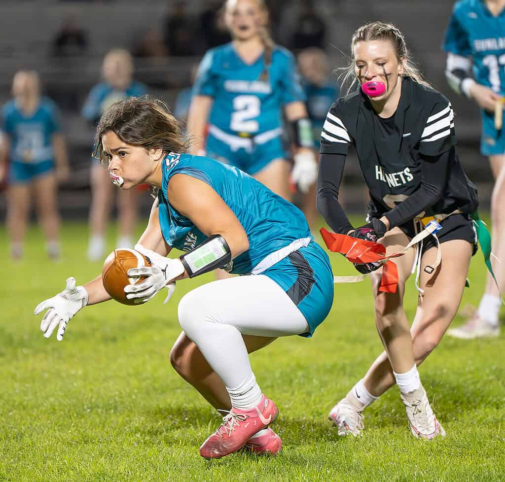 Weeki Wachee High, Arianna Hessler makes a sure pull of the flag on Sunlake QB ,3, Kate Smith Thursday in Brooksville. [Photo by Joe DiCristofalo]