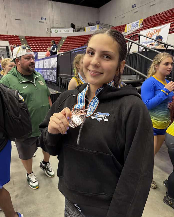 Nature Coast junior weightlifter Keanna Cepeda displays the medal she won for finishing third at Olympic 169 pounds on Friday at the FHSAA 2A State Championships in Lakeland. [Photo provided by Tania Kelly]