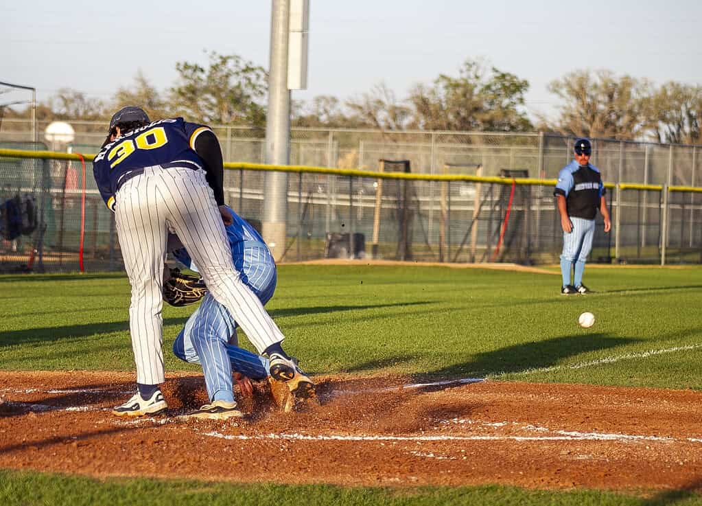 NCT player crashes into Aiden Marsiglio, 30, while trying to get to the home plate during a game at Nature Coast Technical High School in Brooksville, Fla., on Wednesday, March 19, 2025. (Photo by Hanna Maglio)