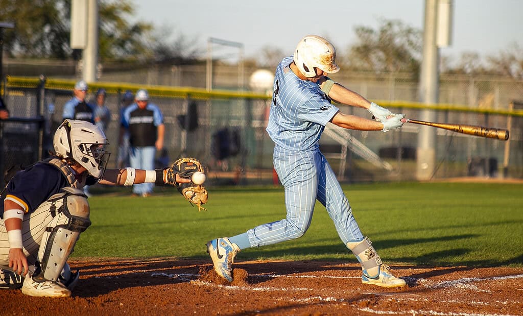 Brady Mcmurdo, 3, misses the ball, but it is caught by the shortstop during a game at Nature Coast Technical High School in Brooksville, Fla., on Wednesday, March 19, 2025. (Photo by Hanna Maglio)