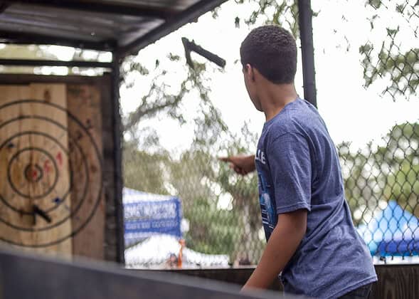 Ely Elwin tries his hand at ax throwing on Saturday at Swamp Fest. [Photo by Hanna Fox Maglio]