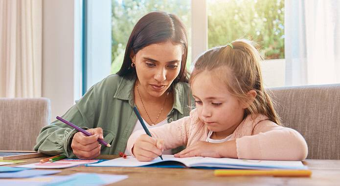 Education, mother and girl with homework, writing and lesson at home, focus and learning. Family, parents and mama with female child, daughter and happy kid with notes, fun or growth with development